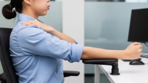 Side view showing the exhale test for armrest height with relaxed shoulders and elbows near the torso