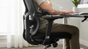 Home office chair with armrests set so shoulders are relaxed and elbows stay close to the body while typing