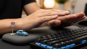Wrist rest used as a parking zone during pauses with wrists lifted during active typing to avoid anchored wrist pressure